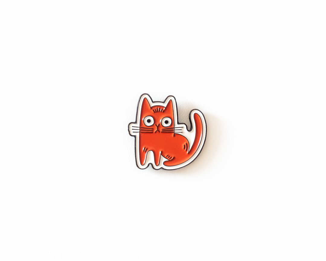 red cat enamel pin on white background