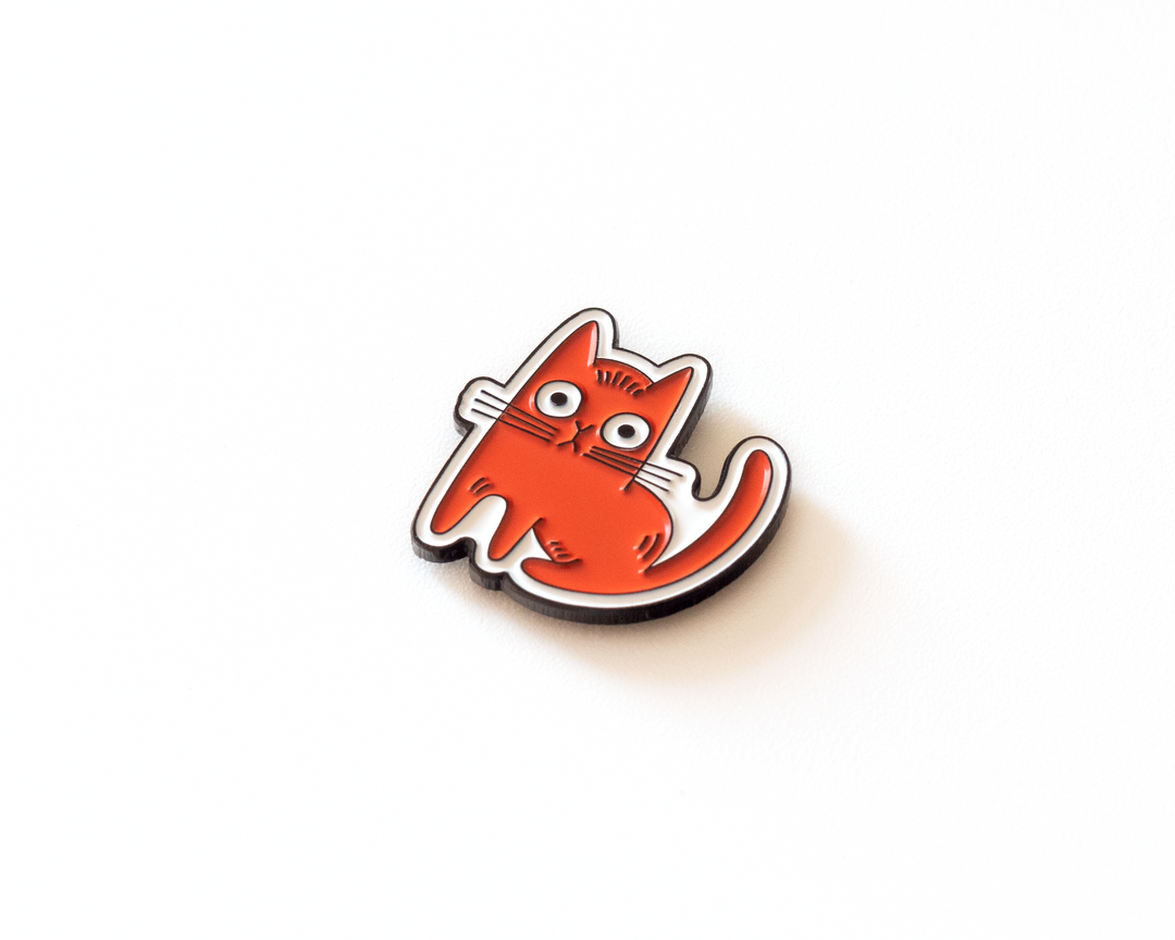 close-up of red cat enamel lapel pin